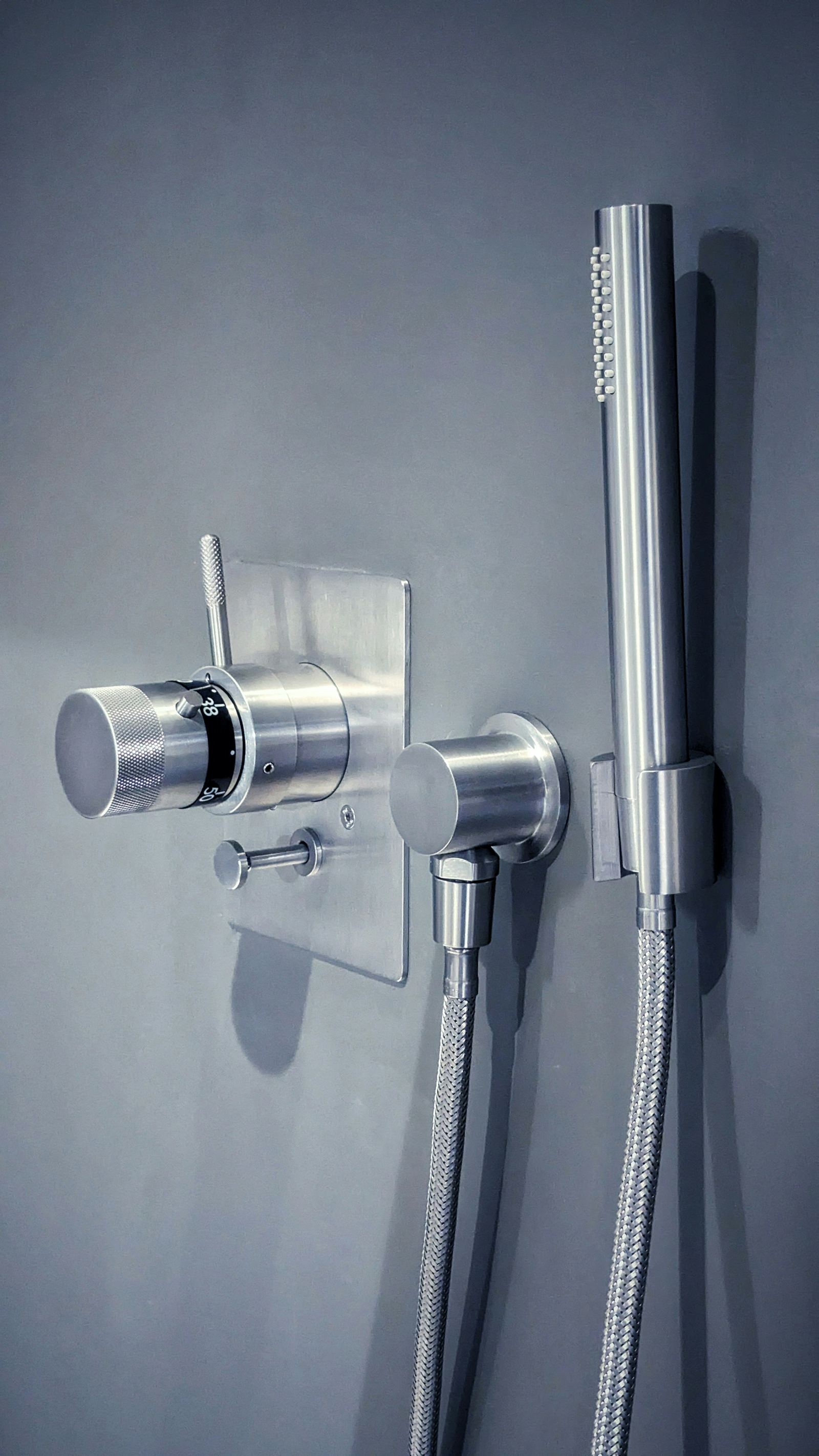 Brushed steel shower fixtures installed by Tidewell