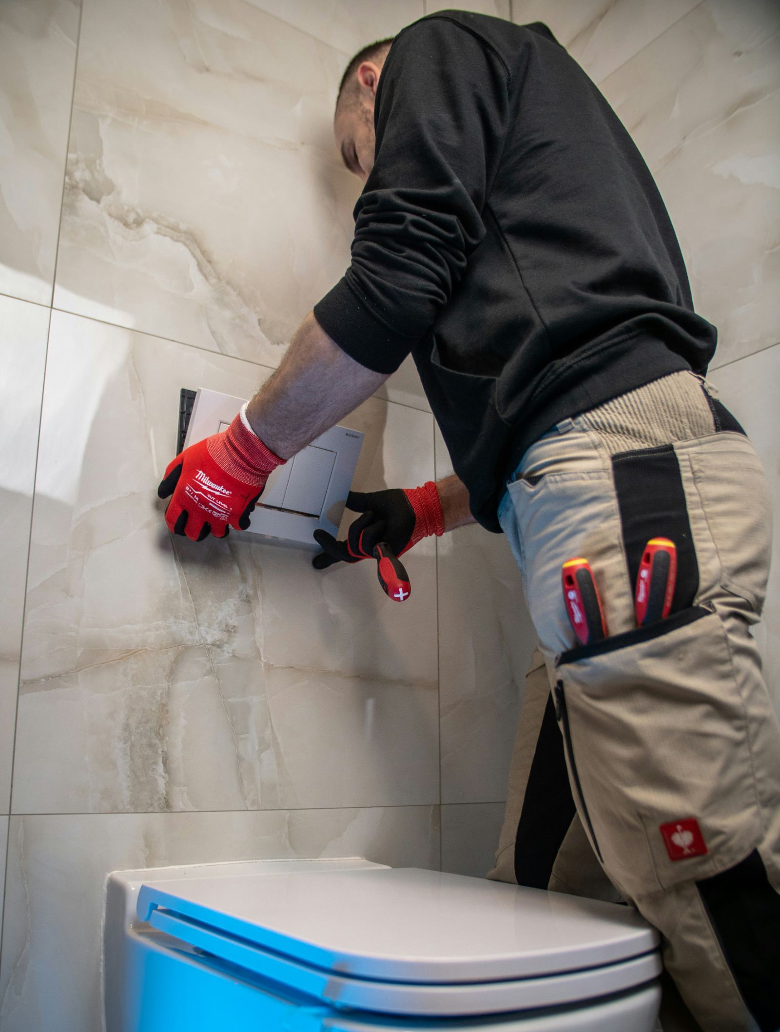 Technician installing a wall flush plate
