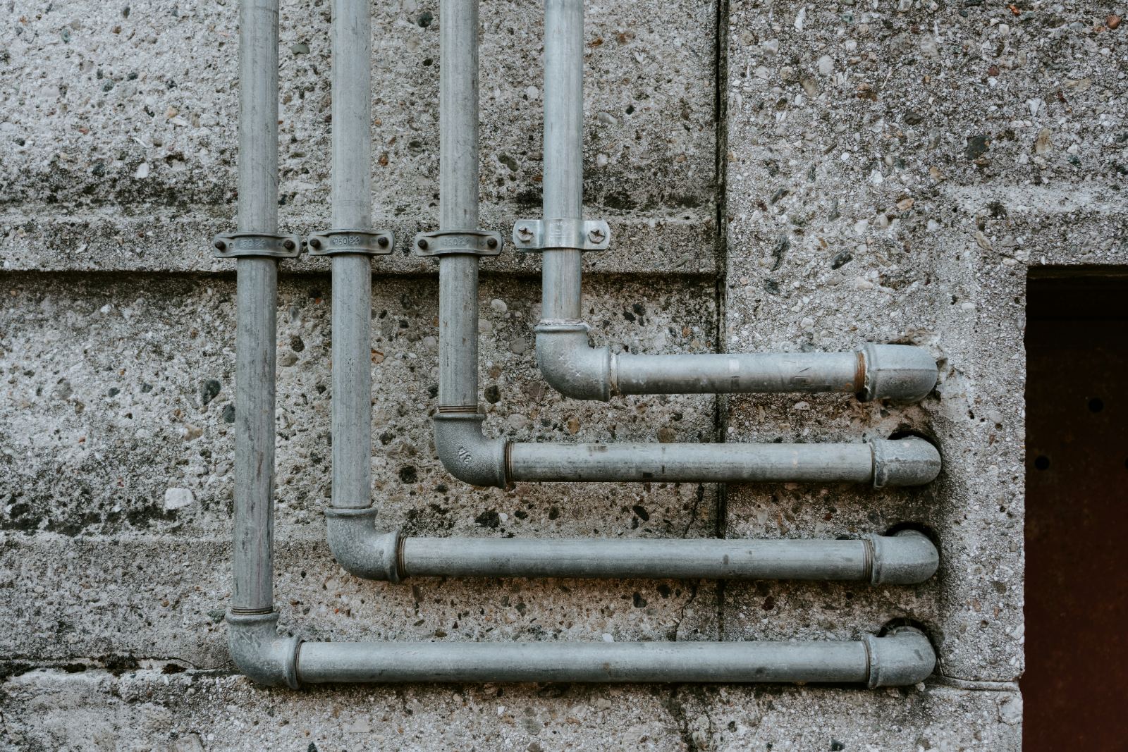 Galvanized supply pipes on a wall