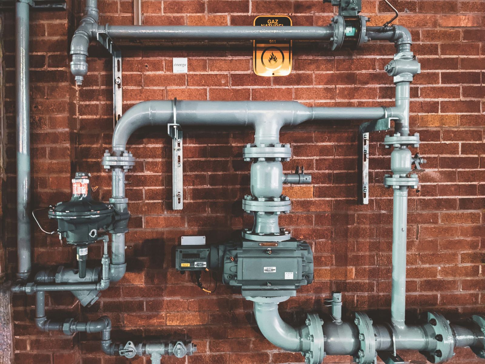 Gas line assembly on a brick wall